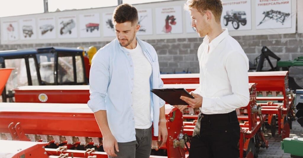 Two men discussing agricultural equipment at an outdoor store during the day.