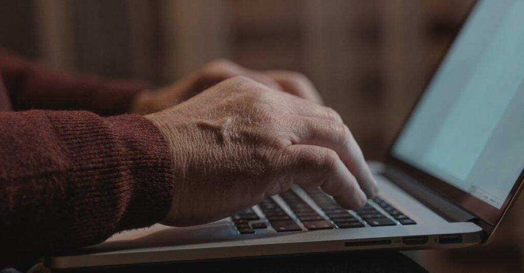 Close-up of hands typing on a laptop keyboard, ideal for business and technology themes.