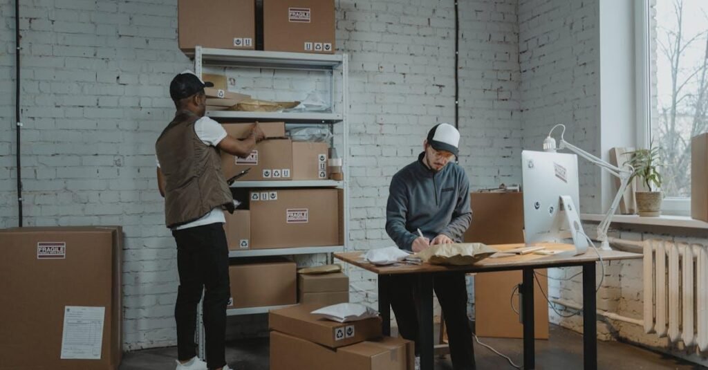 Two workers handling packages and organizing stock in a warehouse setting.