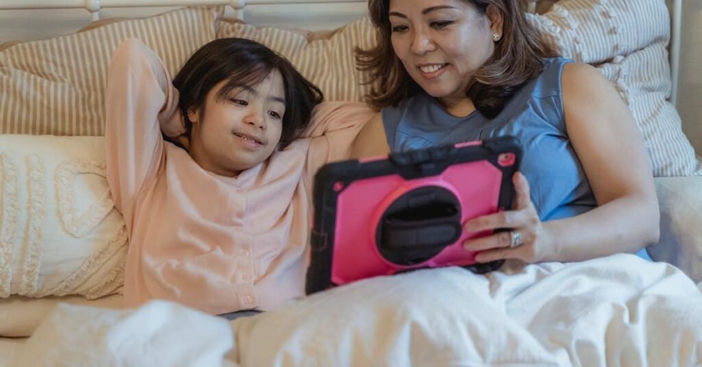 Mother and daughter bonding over a tablet in a cozy home setting.